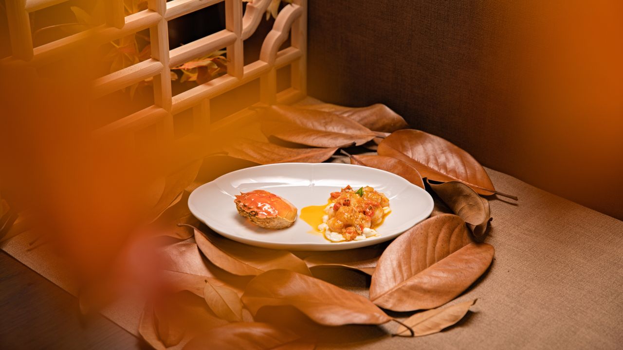 Mastering the First Impression: Your intriguing post title goes here Gourmet dish elegantly plated with autumn leaves and warm orange lighting, evoking a cozy, seasonal atmosphere.